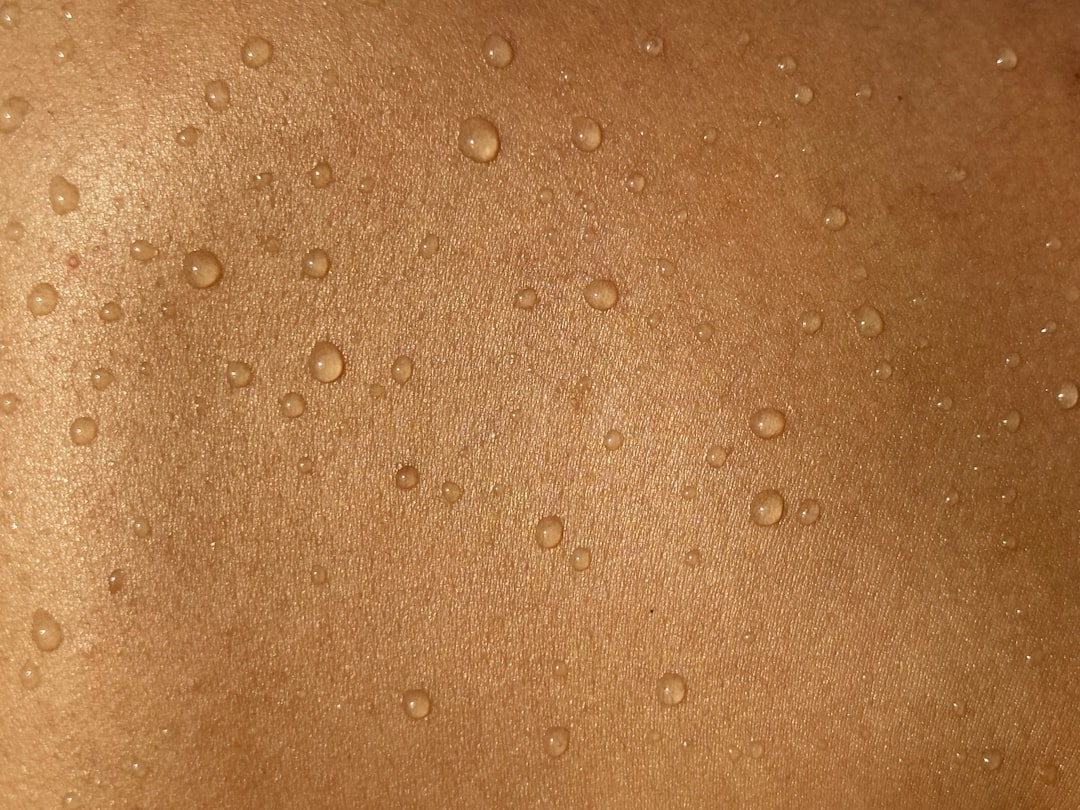 A serene image of a person applying moisturizer to their face, showcasing a gentle skincare routine for dry and sensitive skin.