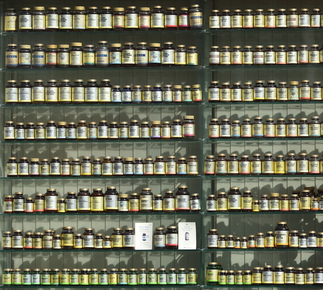 A neatly organized medicine cabinet with labeled containers for medications and supplements, showcasing a clean and safe storage solution.