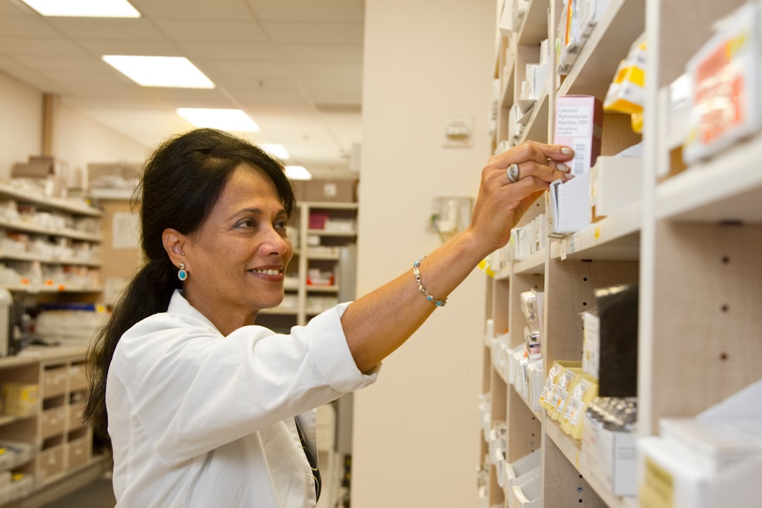 A pharmacist assisting a customer in a pharmacy, discussing over-the-counter products.